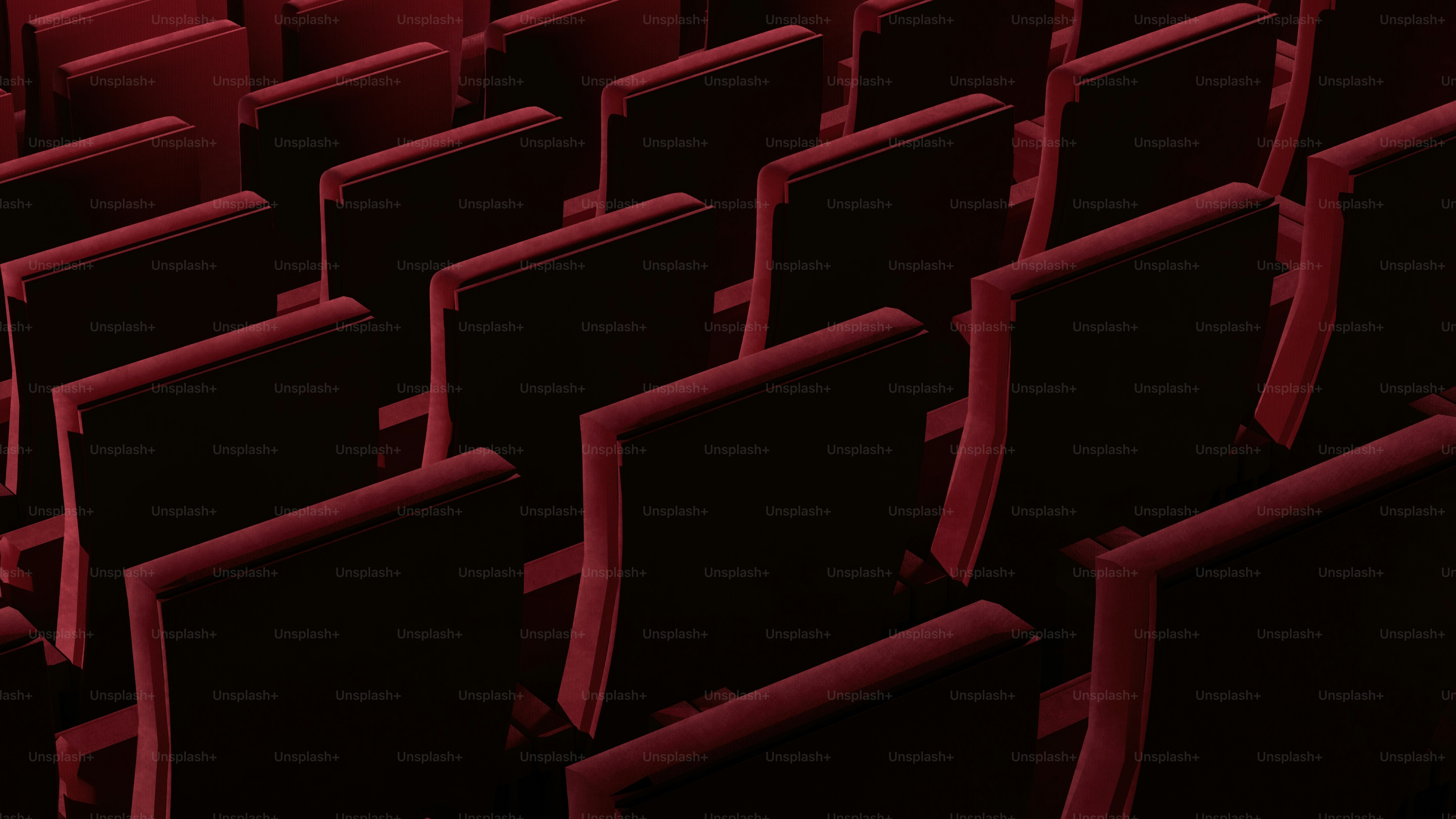 rows of black and red seats in a theater