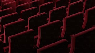 rows of black and red seats in a theater