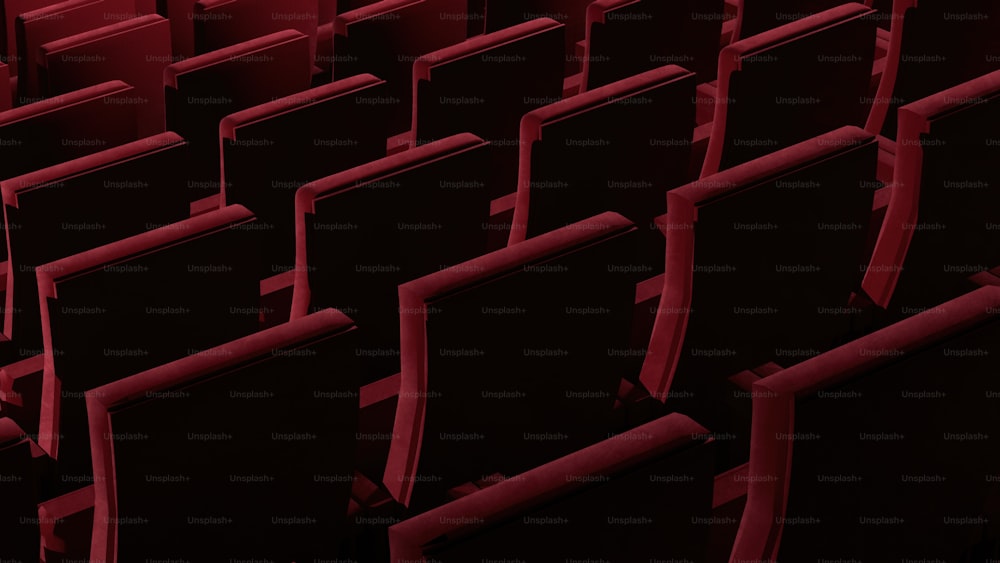 rows of black and red seats in a theater
