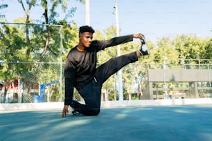 a man doing a kickbox pose on a tennis court