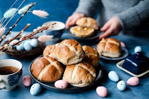 a table topped with plates of hot cross buns