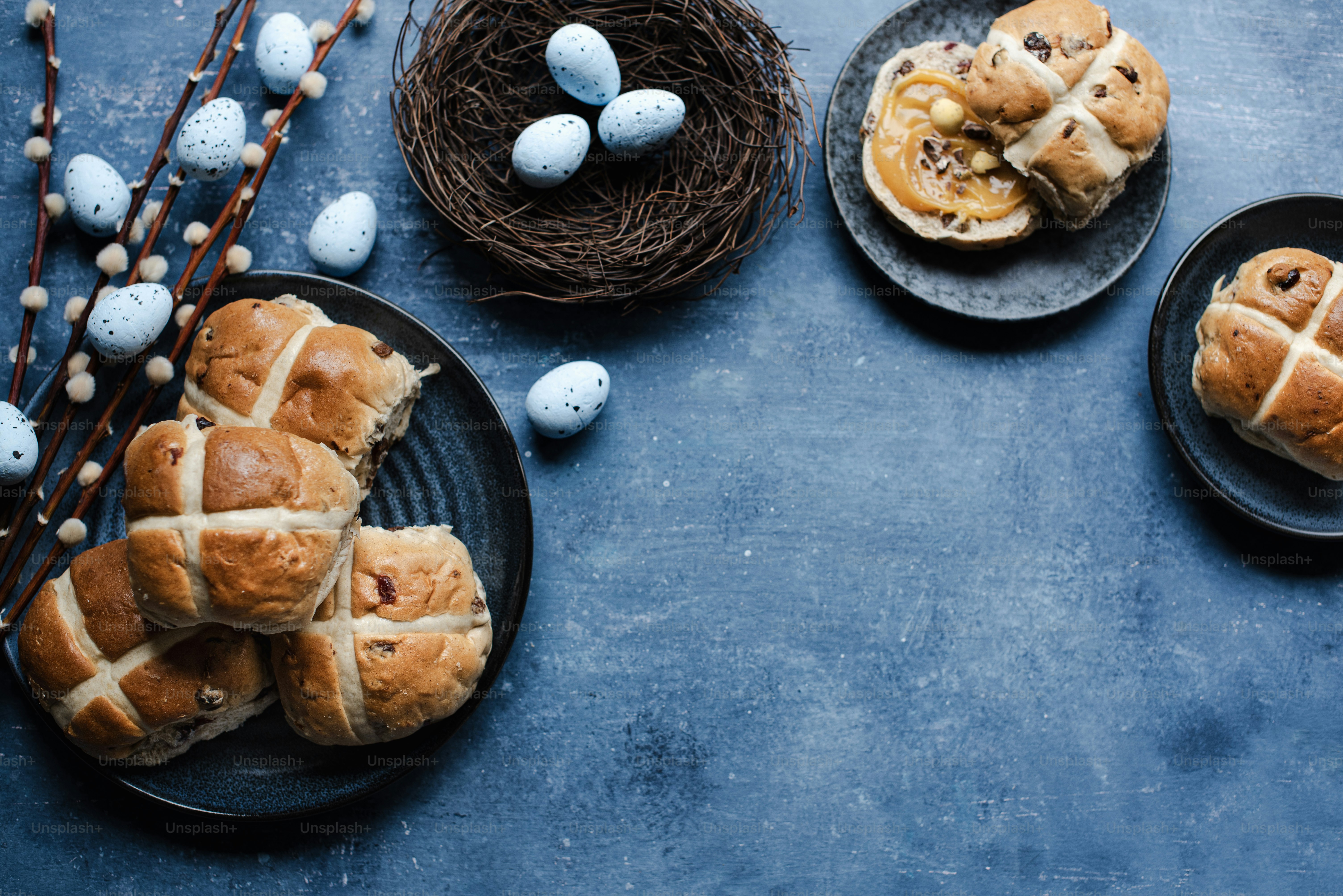 A table topped with hot cross buns and eggs photo – Easter dishes Image ...