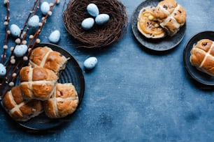 a table topped with plates of hot cross buns