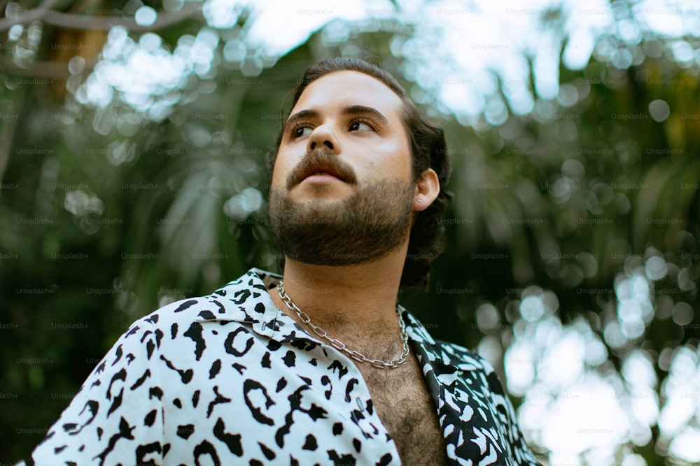 a man with a beard wearing a leopard print shirt
