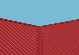 una pared roja con un cielo azul de fondo