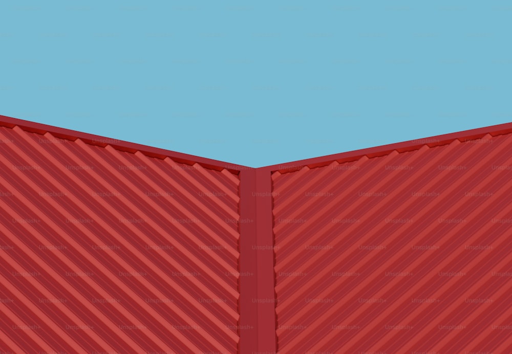 un mur rouge avec un ciel bleu en arrière-plan