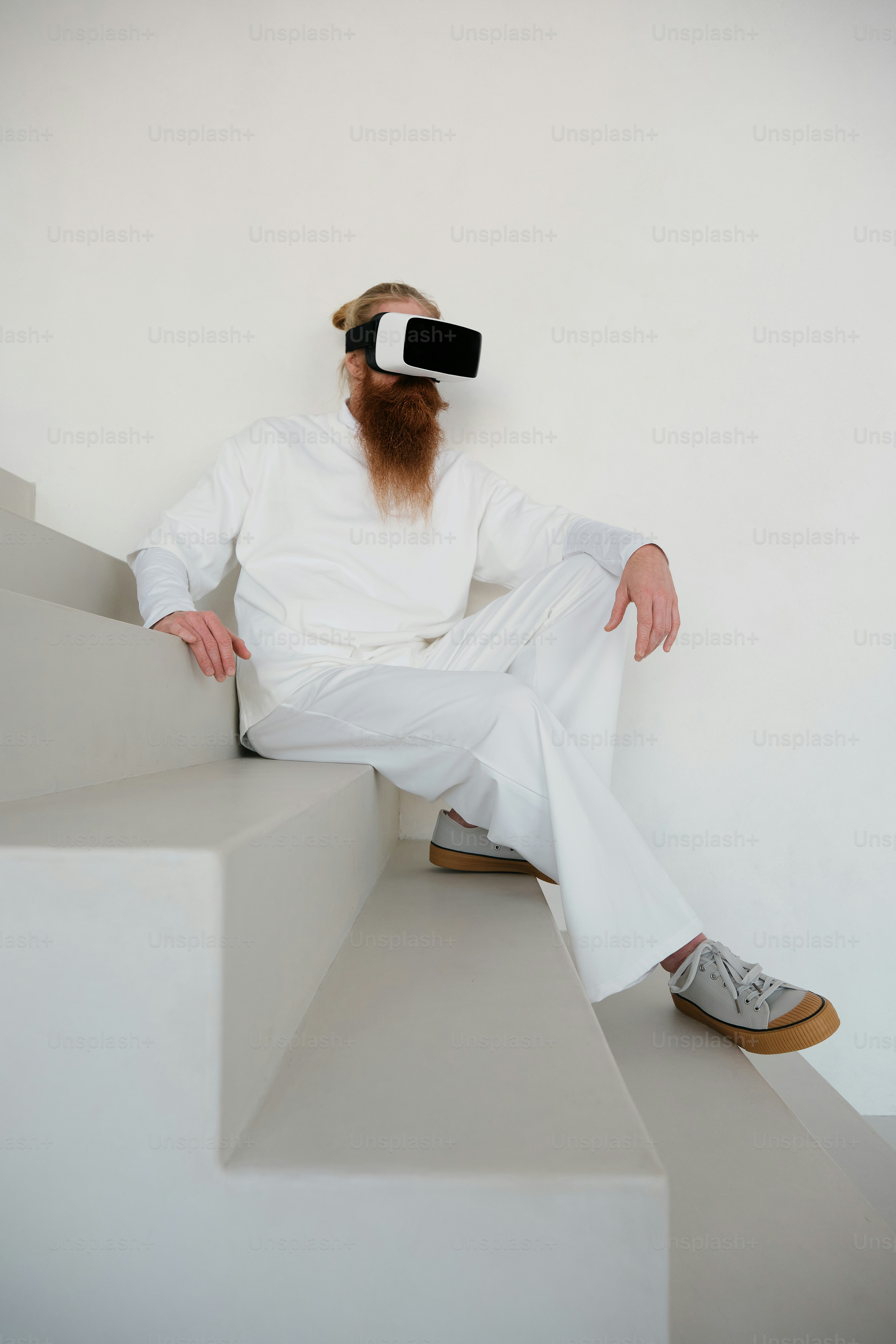 a man with a beard sitting on a set of stairs