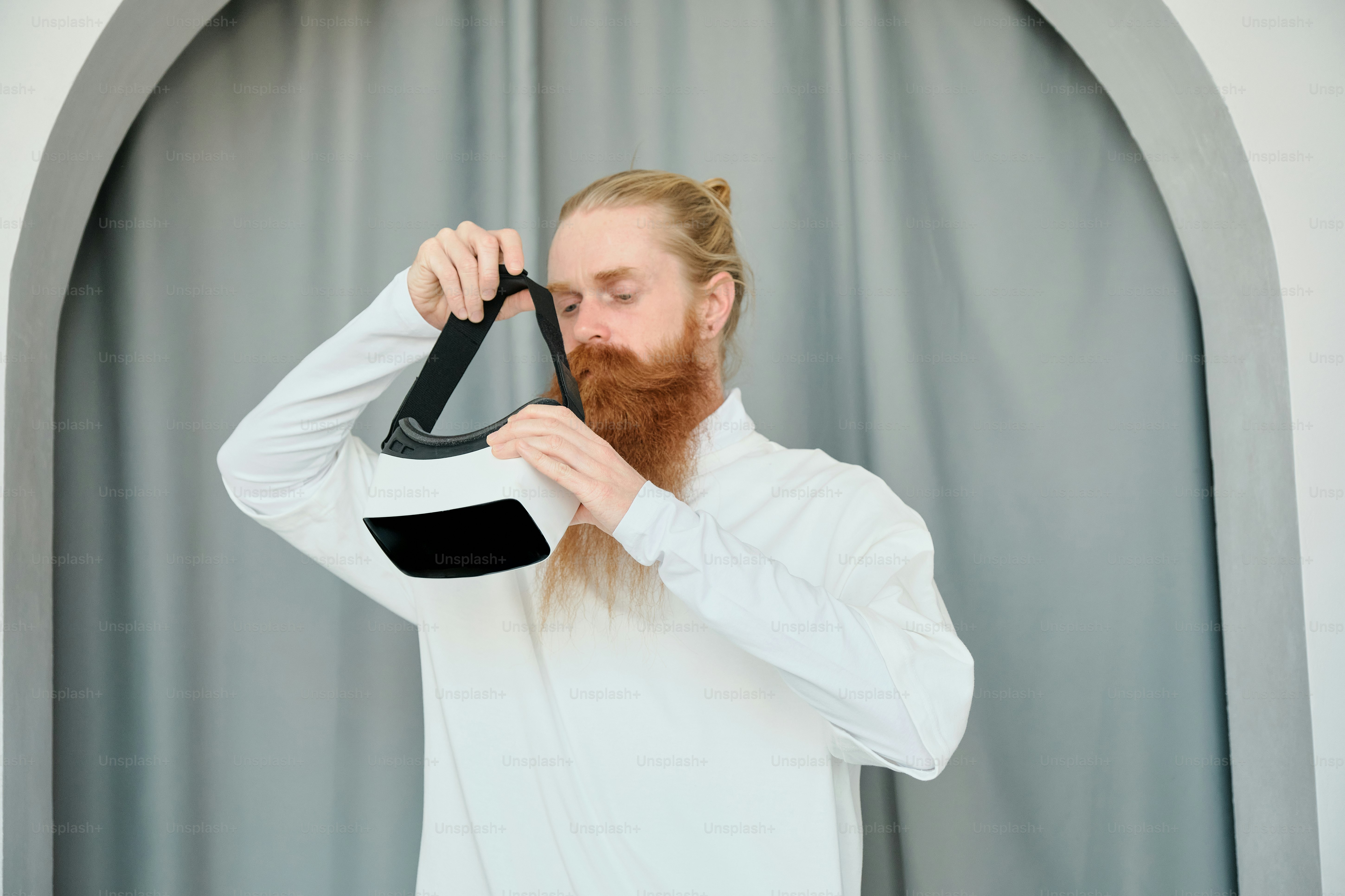 a man with a beard is holding a pair of scissors