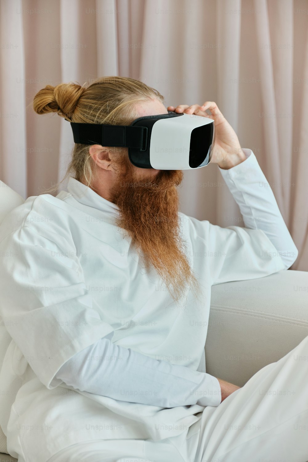 a man with a long red beard wearing a virtual reality headset