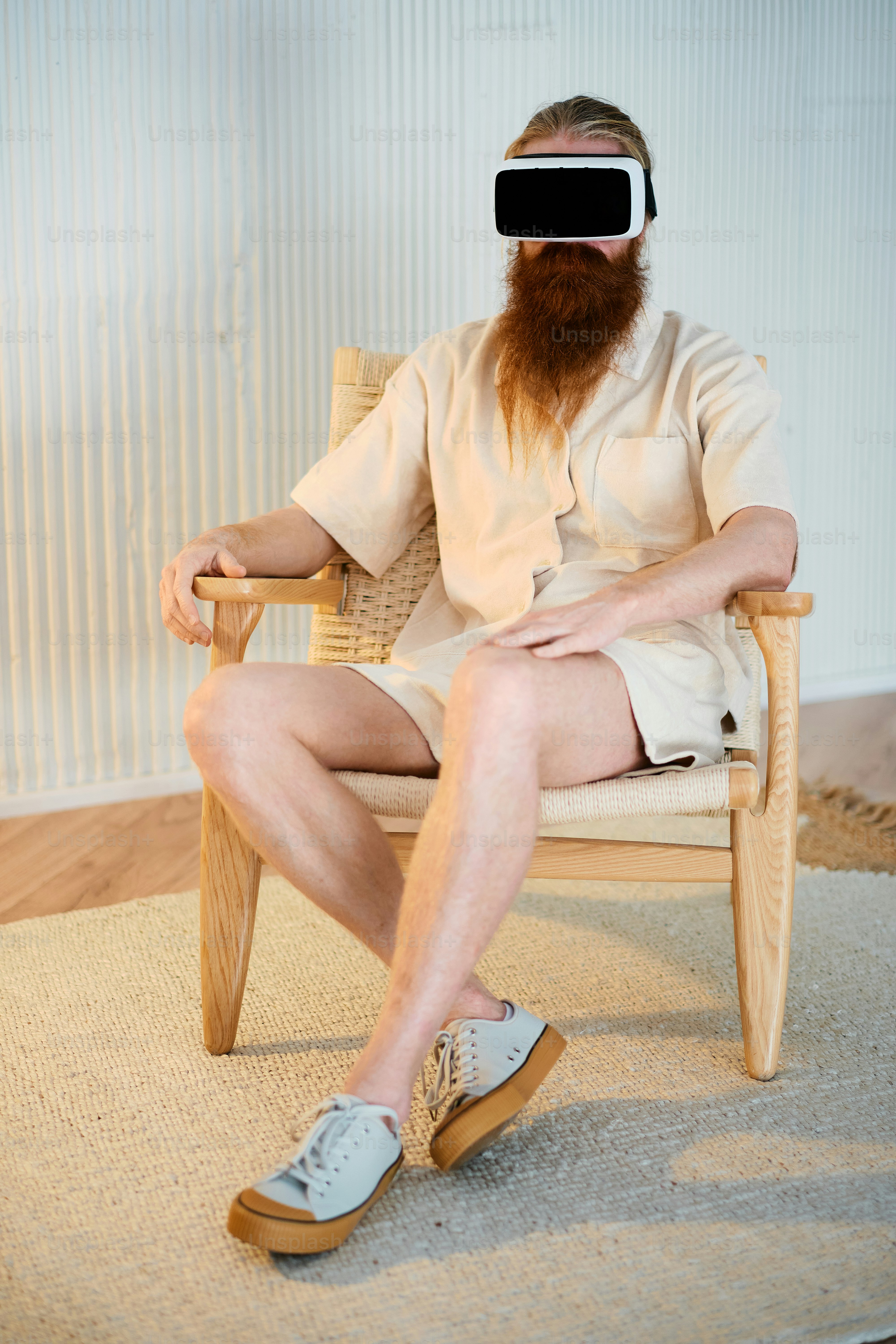 a man sitting in a chair wearing a virtual headset