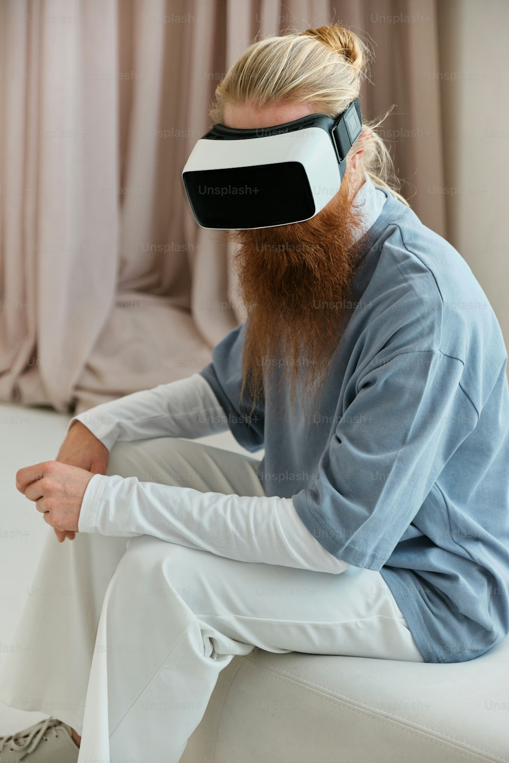 a man with a beard wearing a blindfold