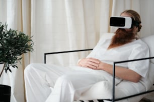 a man sitting in a chair wearing a virtual reality headset