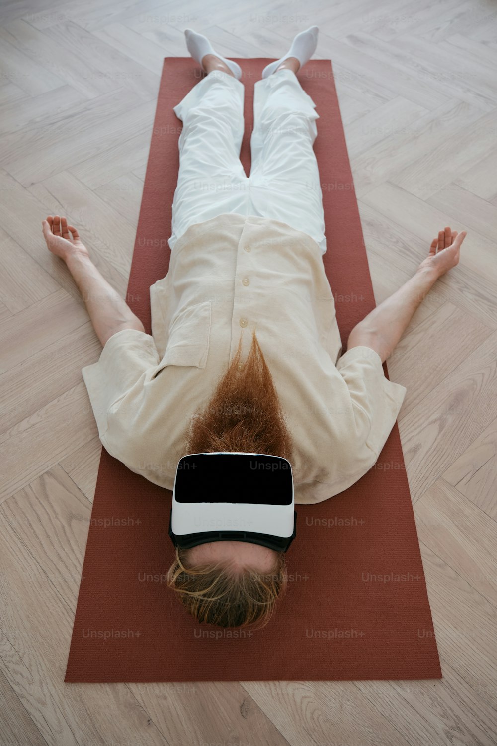 a person laying on a yoga mat with a blindfold on their head