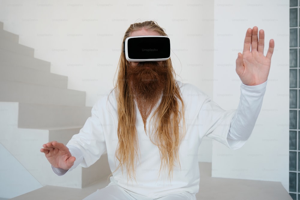 a man with long hair wearing a virtual reality headset