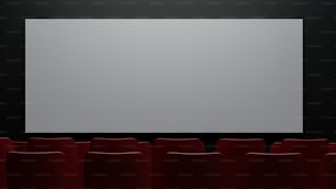 una gran pantalla en una habitación oscura con sillas rojas