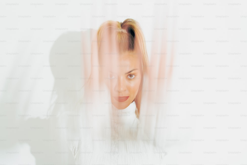 a woman with blonde hair and a white shirt