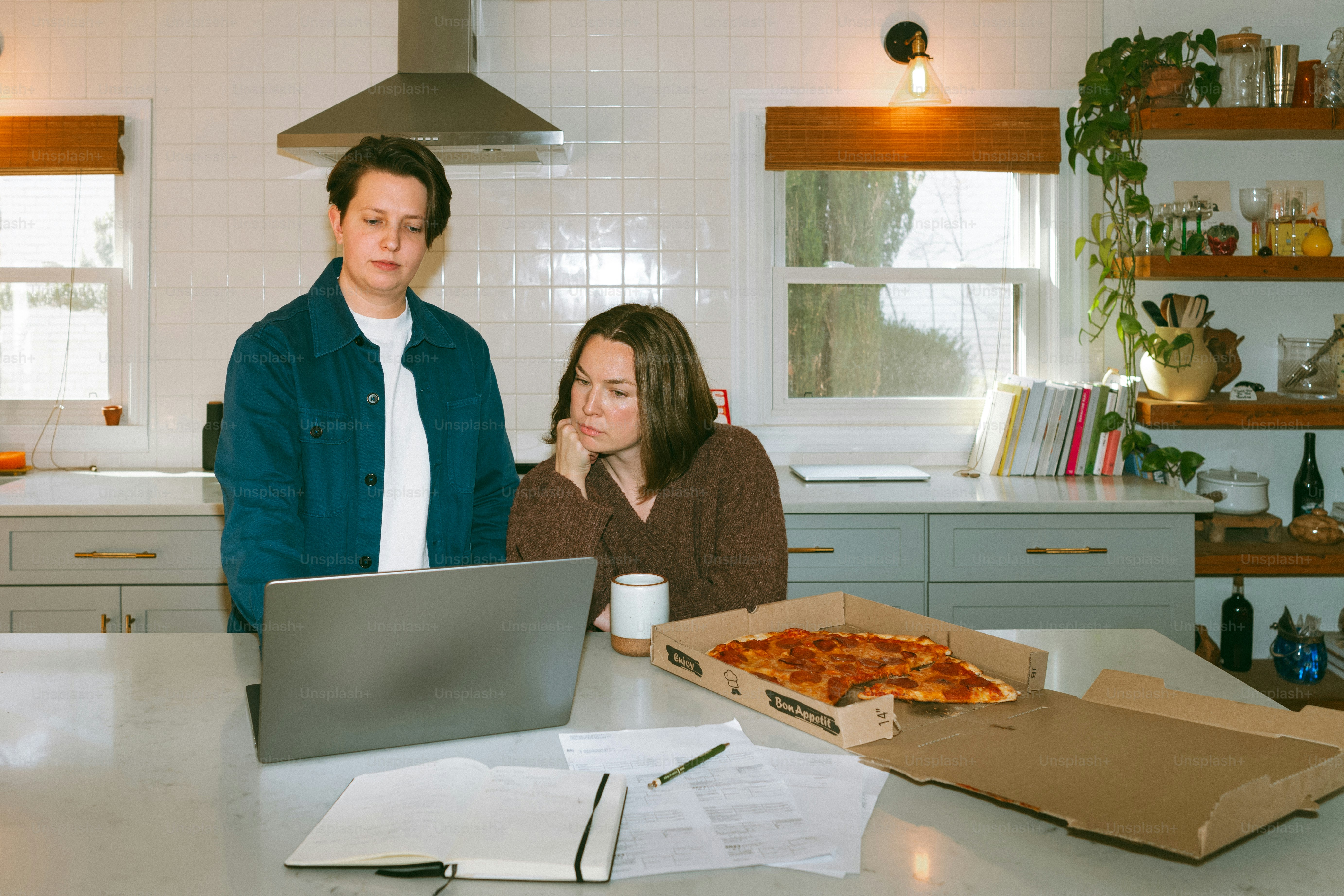 a man and a woman looking at a laptop