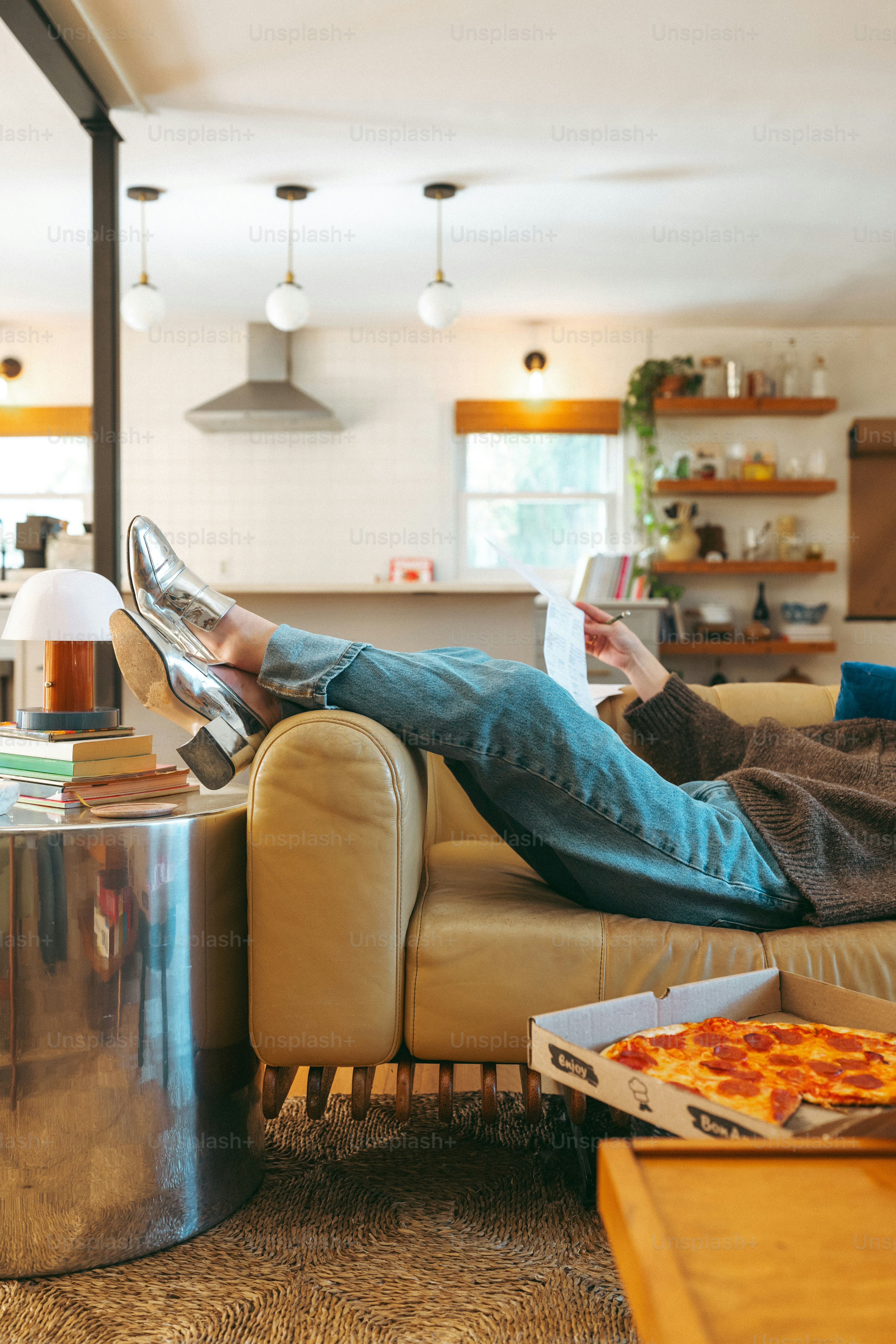 a man sitting on a couch reading a book