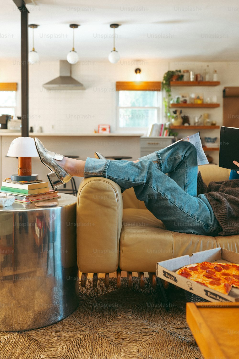 a person sitting on a couch with a laptop