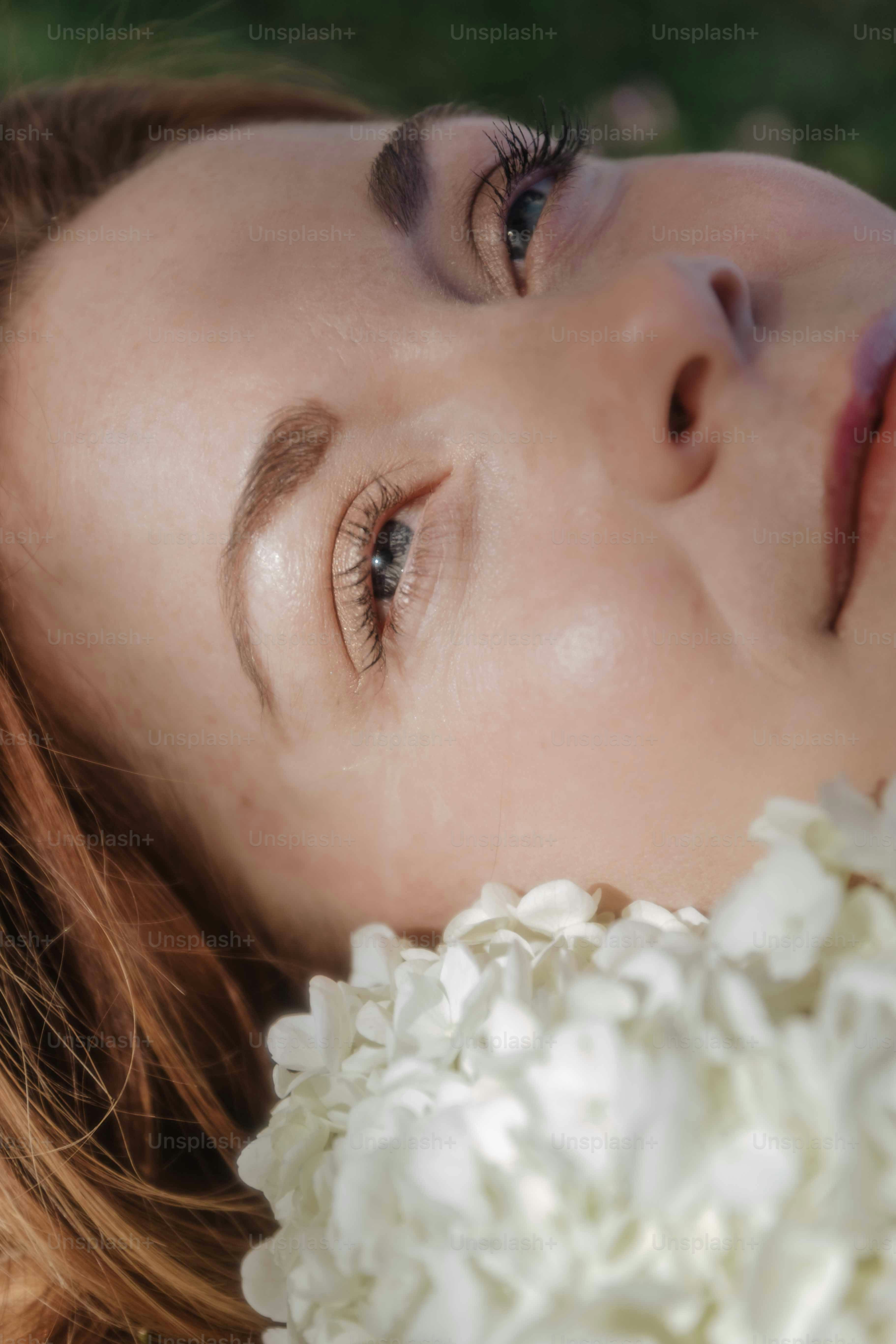 a close up of a woman with flowers in her hair