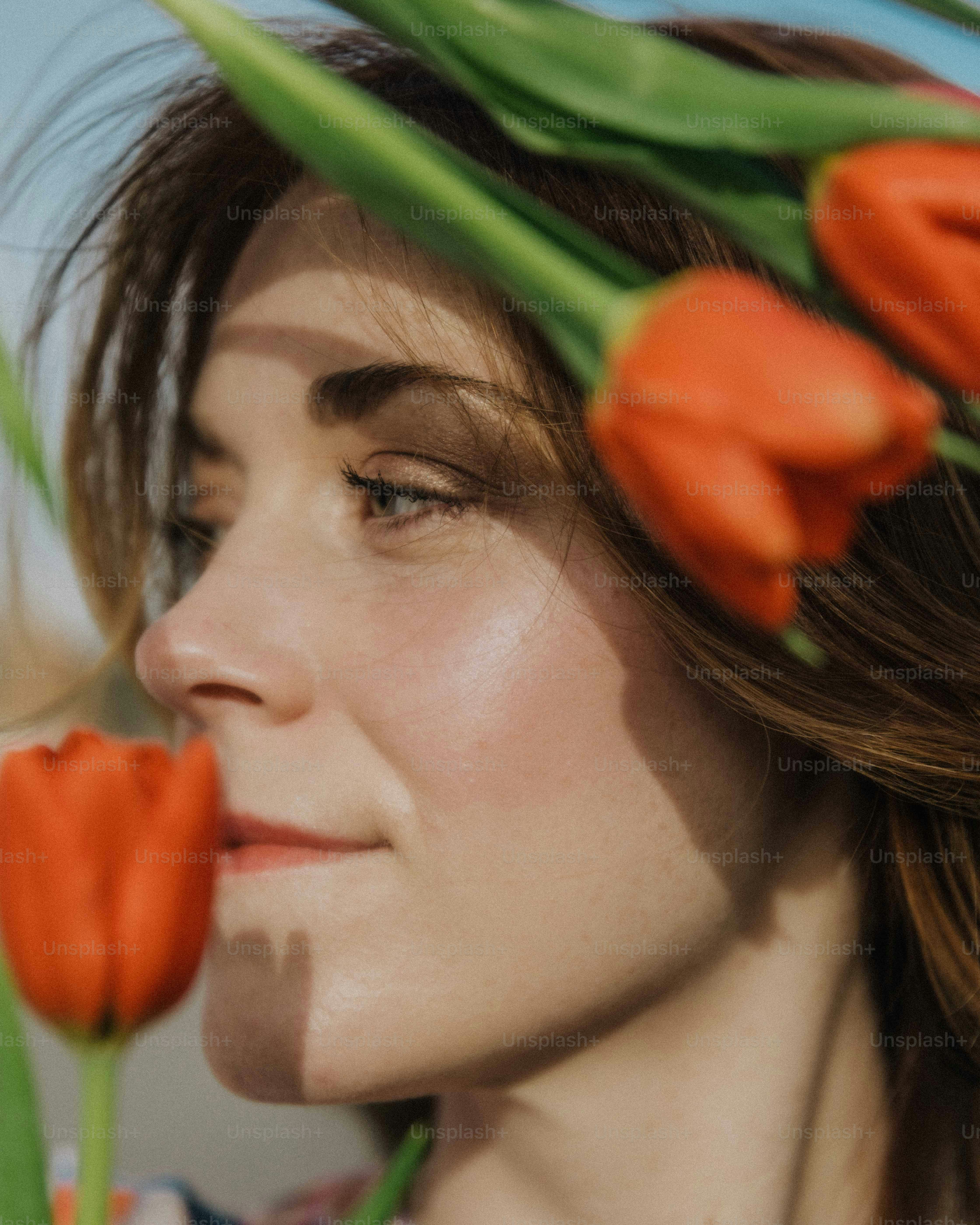 a close up of a woman with flowers in her hair