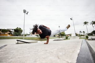 a man doing a handstand on a skateboard