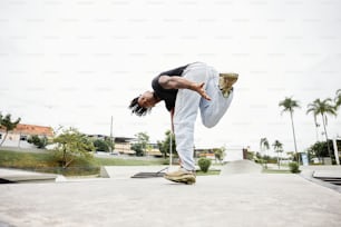 a man doing a handstand on a skateboard