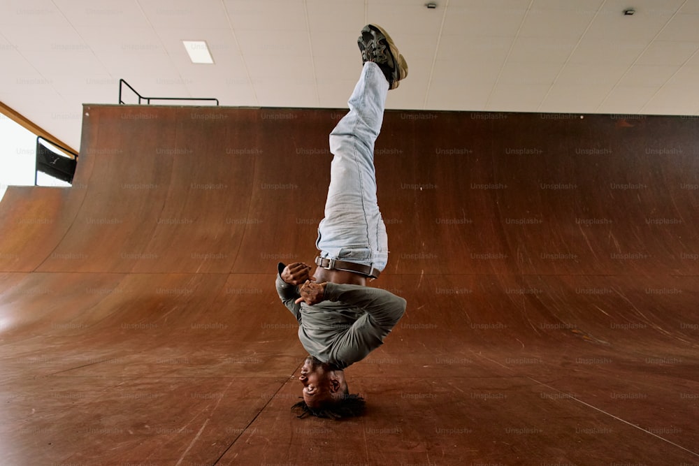 a person doing a handstand on a skateboard
