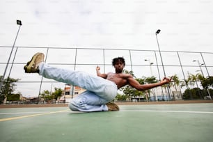 a man doing a handstand on a tennis court