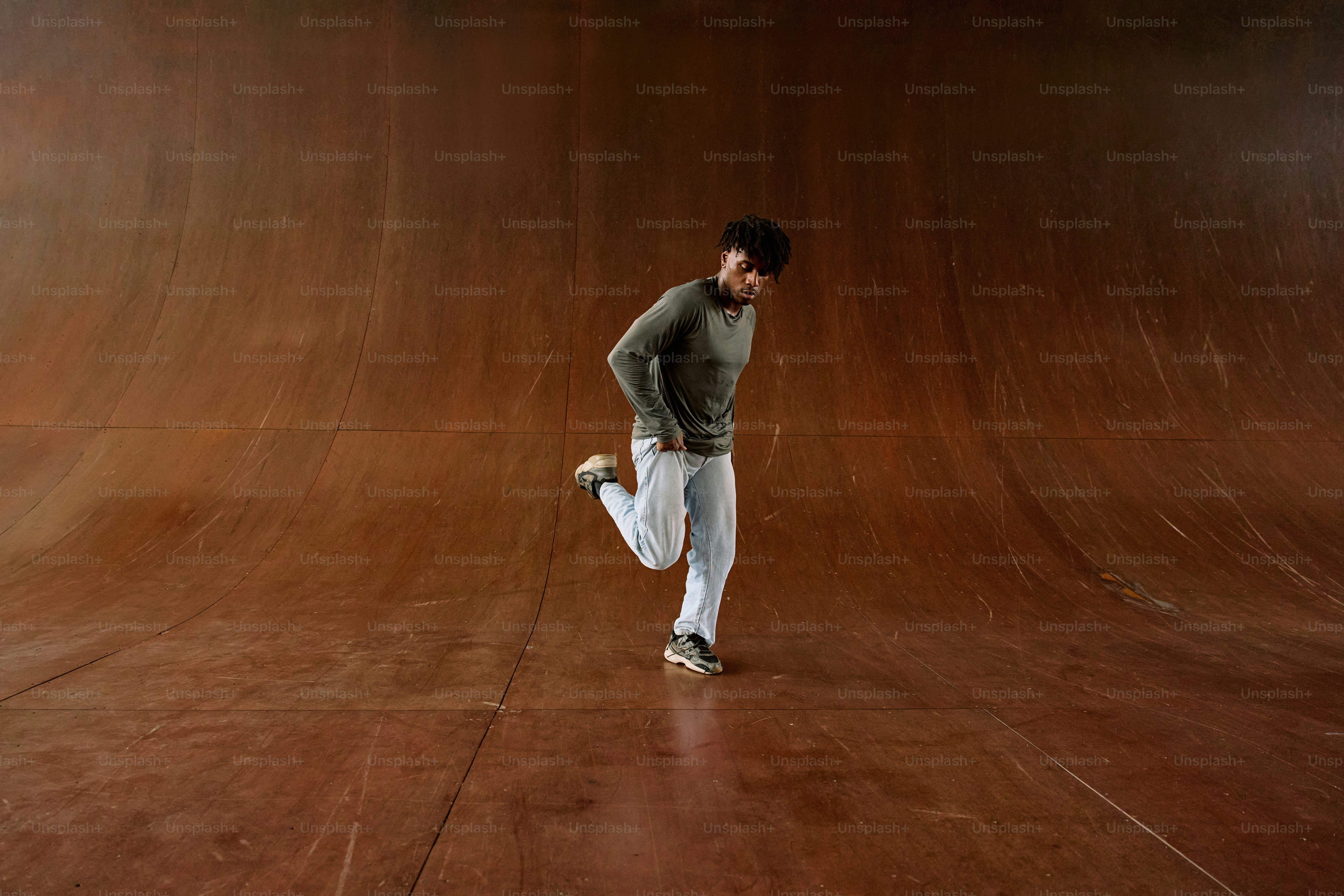 a man standing on a skateboard in a skate park