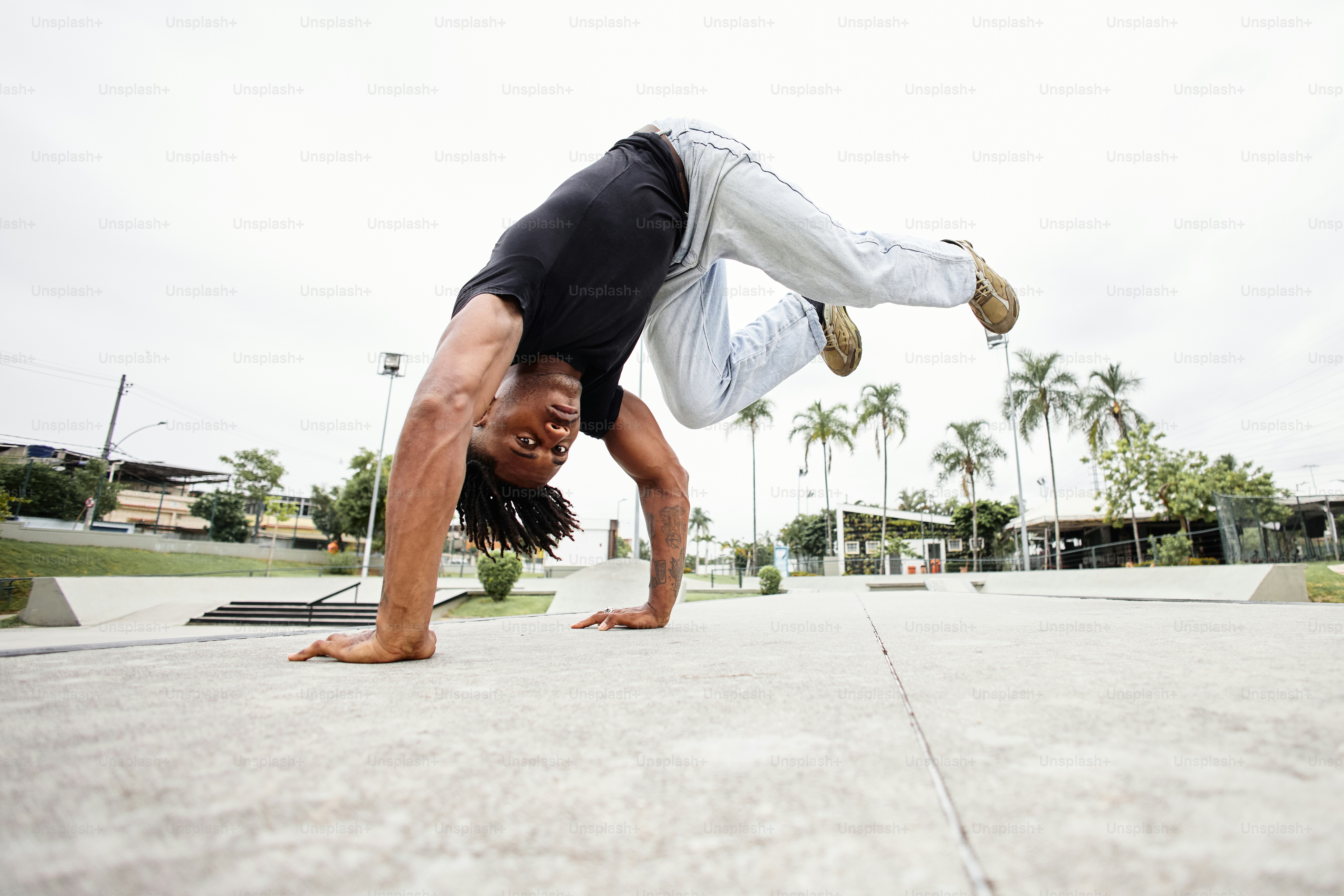 a man doing a handstand on a skateboard