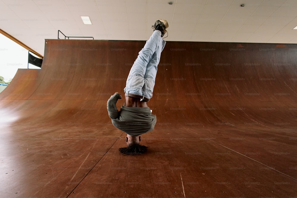 a person doing a handstand on a skateboard