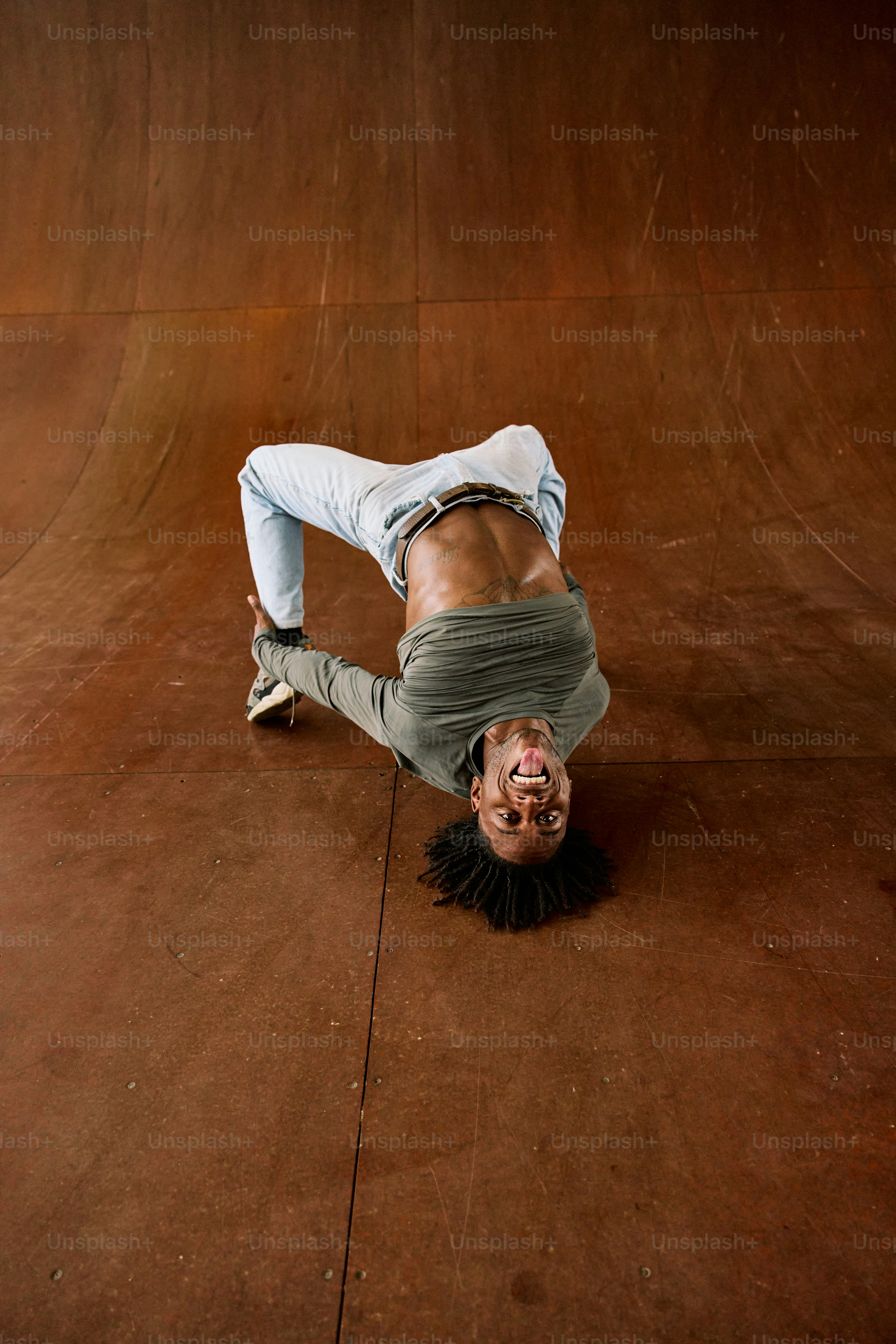 a man is doing a handstand on a skateboard