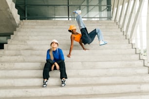 a couple of people that are sitting on some stairs