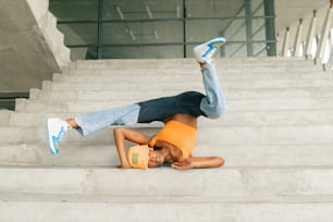 a man laying on top of a set of stairs
