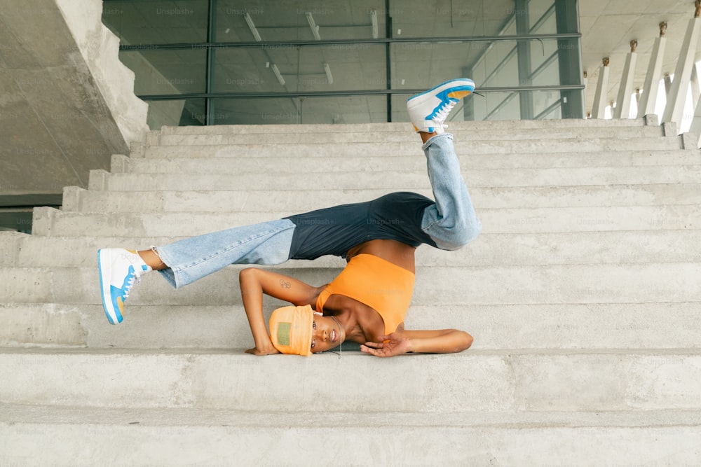 a man laying on top of a set of stairs