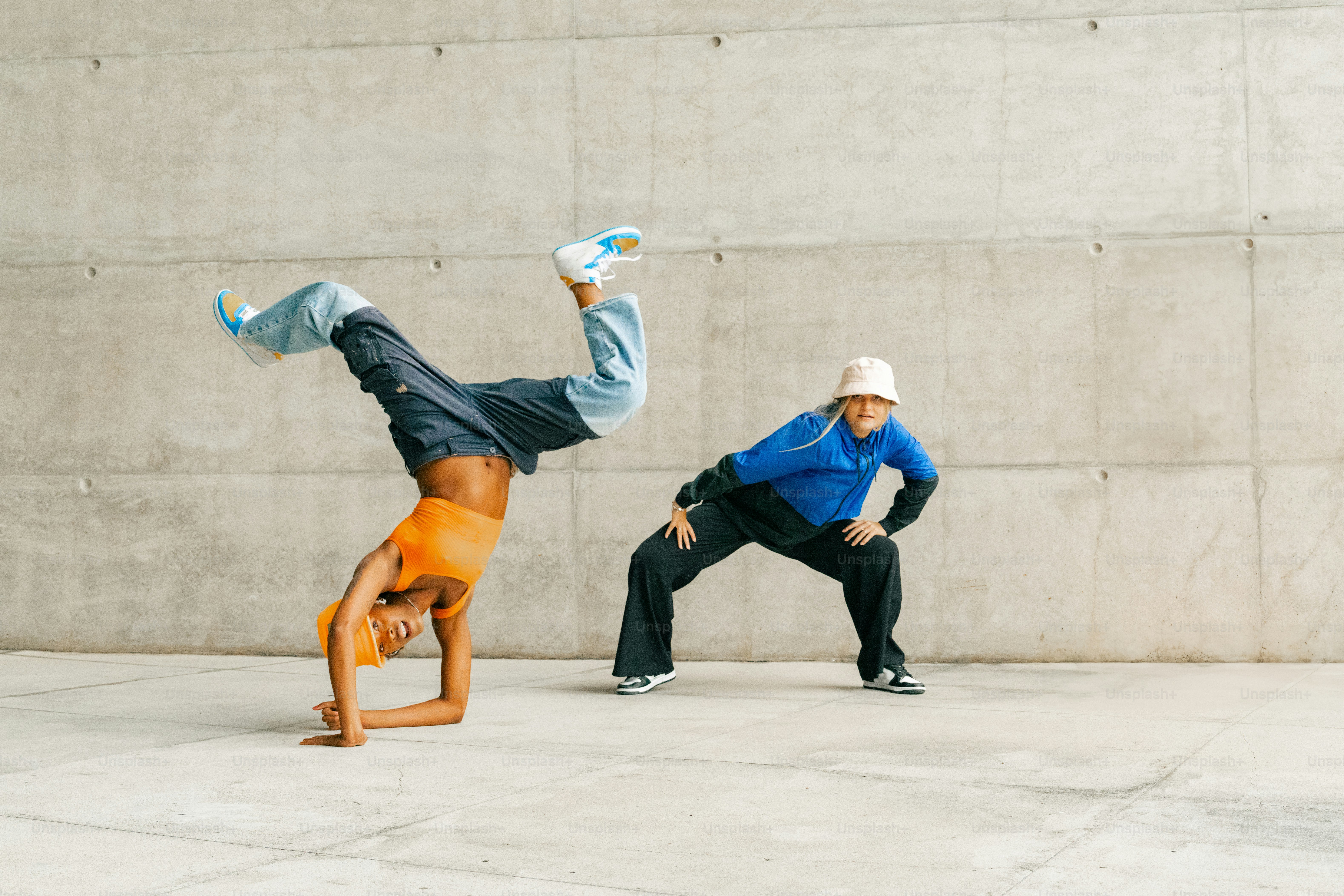 a man doing a handstand while another man watches