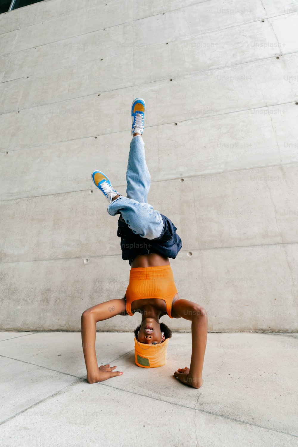 a person doing a handstand in front of a building