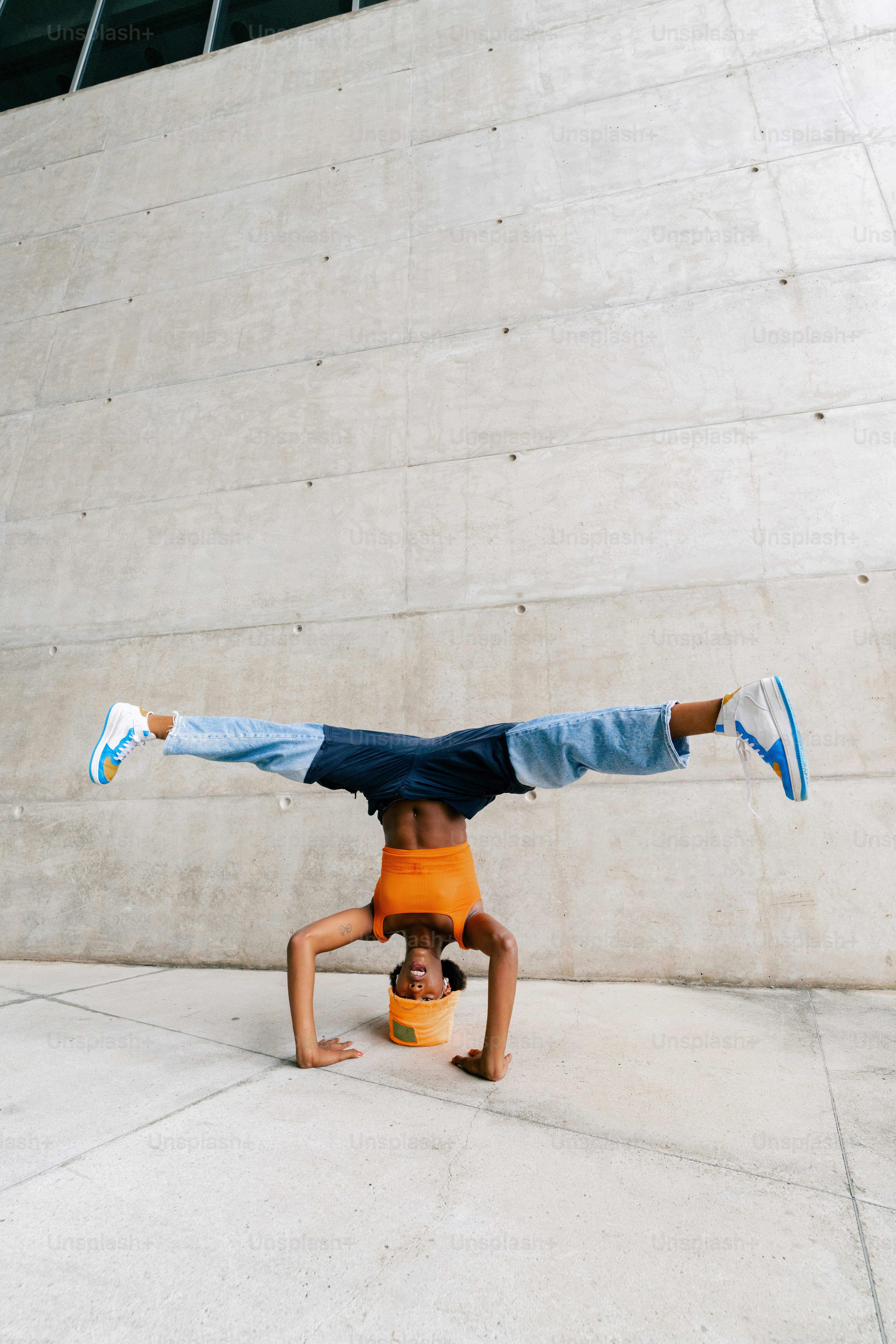 a man doing a handstand on a skateboard