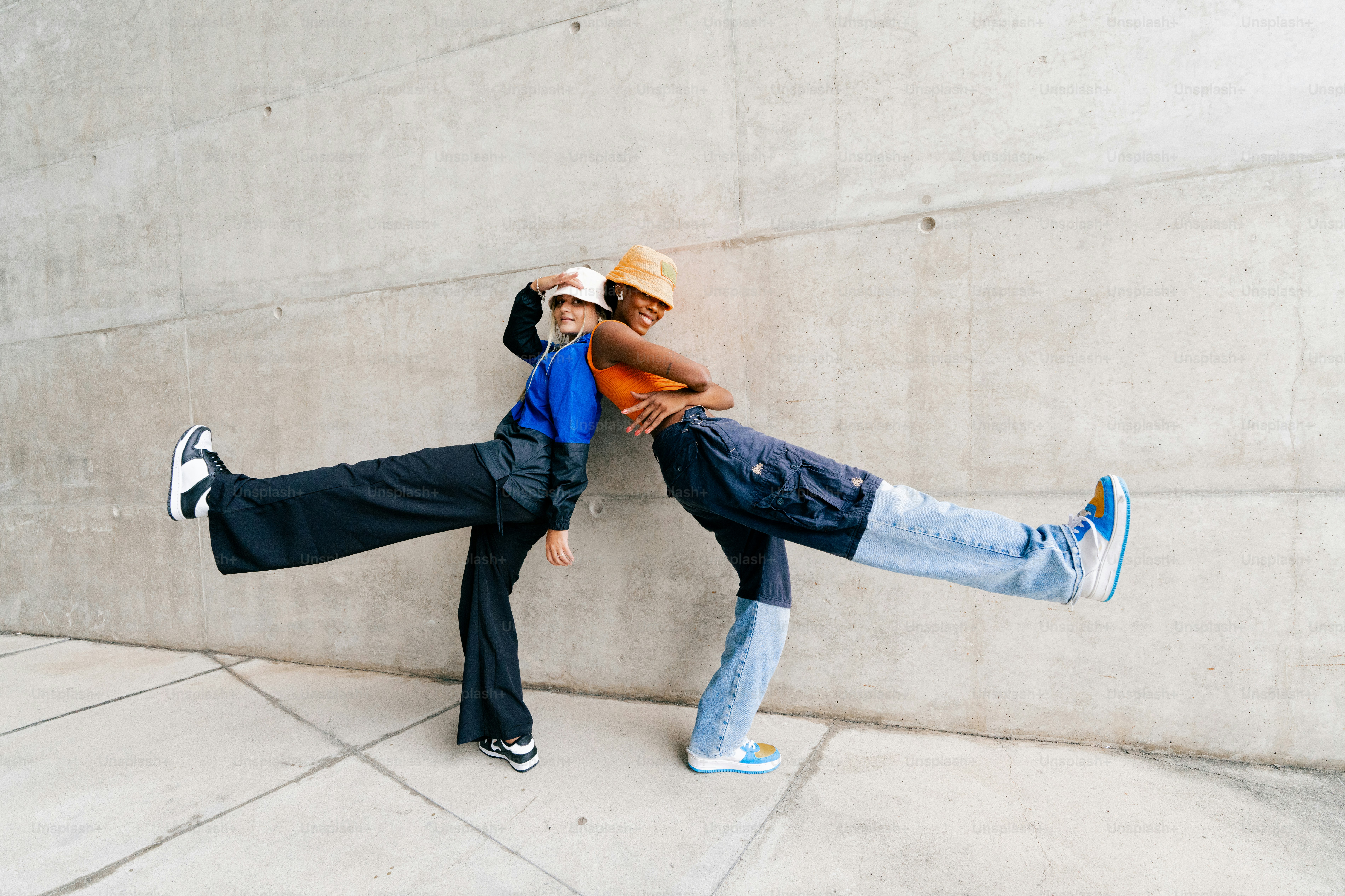 a couple of people that are leaning against a wall