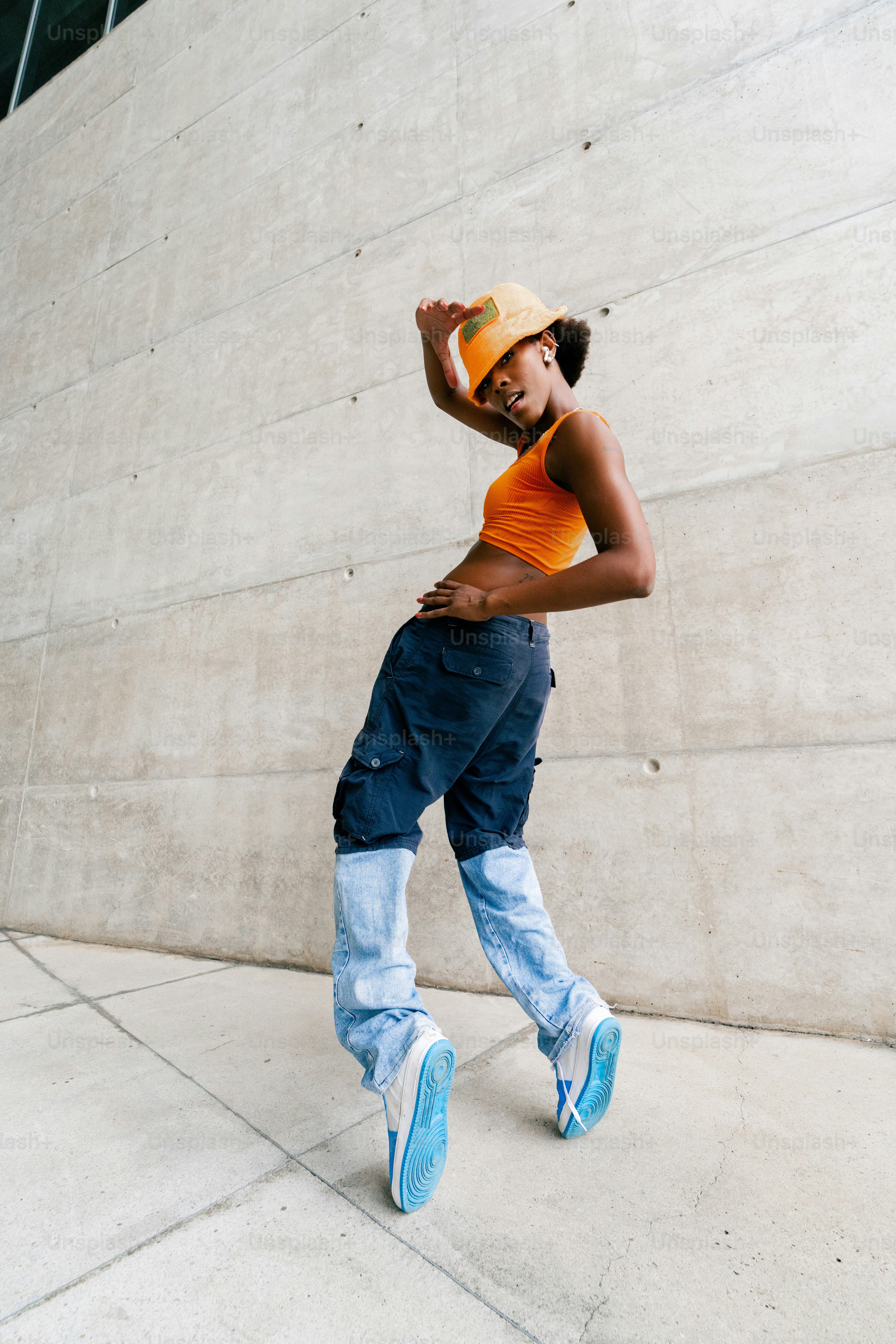 a young man in a yellow shirt and blue pants