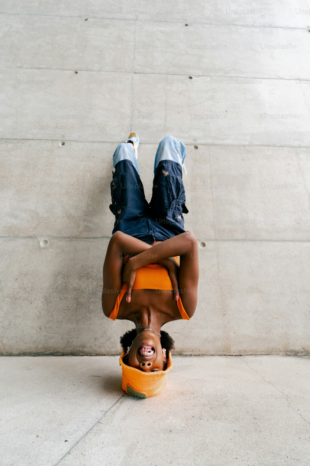 a person upside down on a yellow object