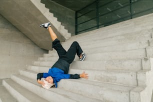 a skateboarder is falling down a set of stairs