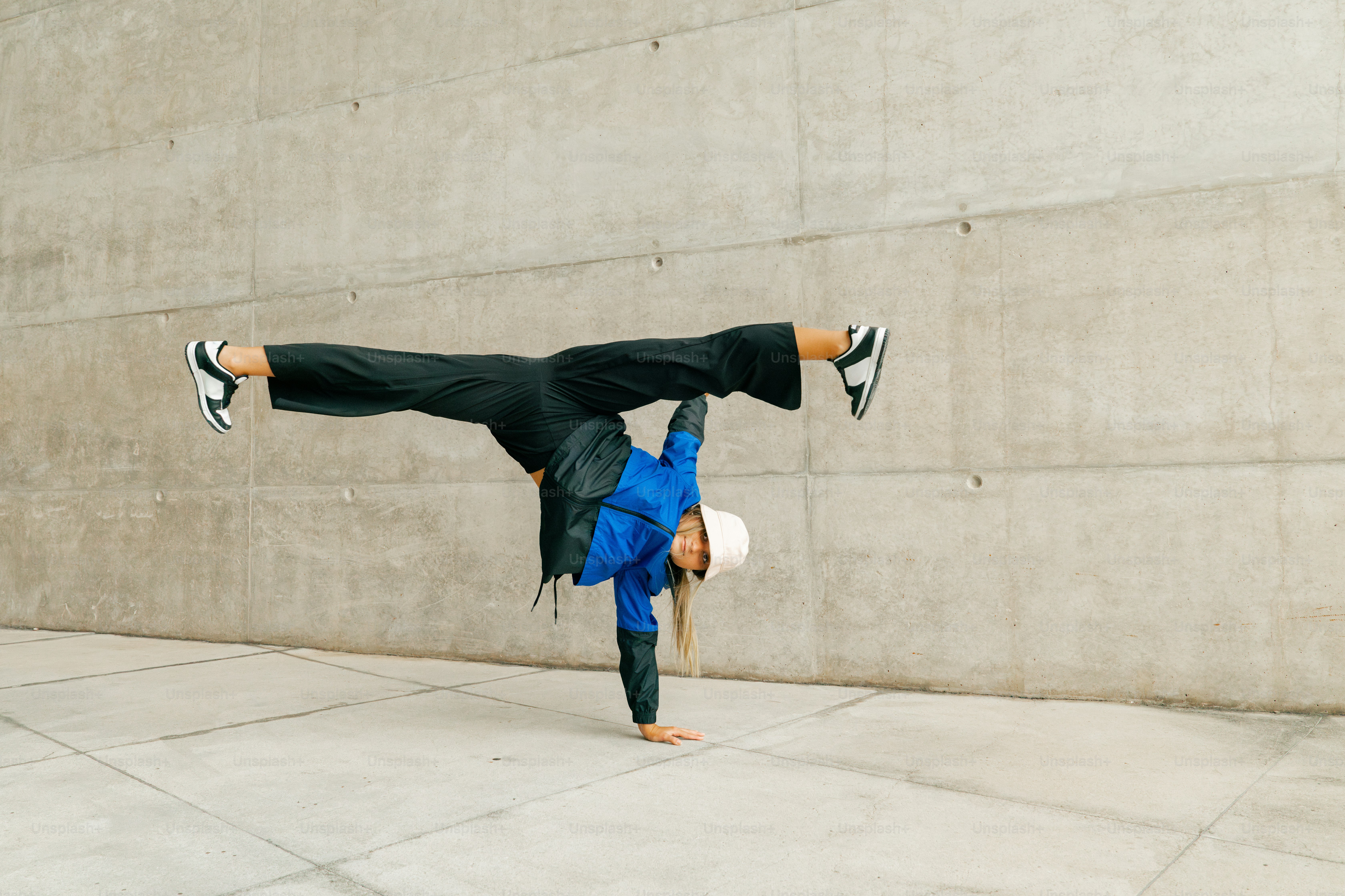 a man doing a handstand on a sidewalk