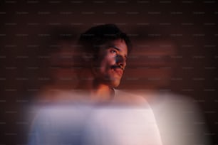 a blurry photo of a man in a white shirt