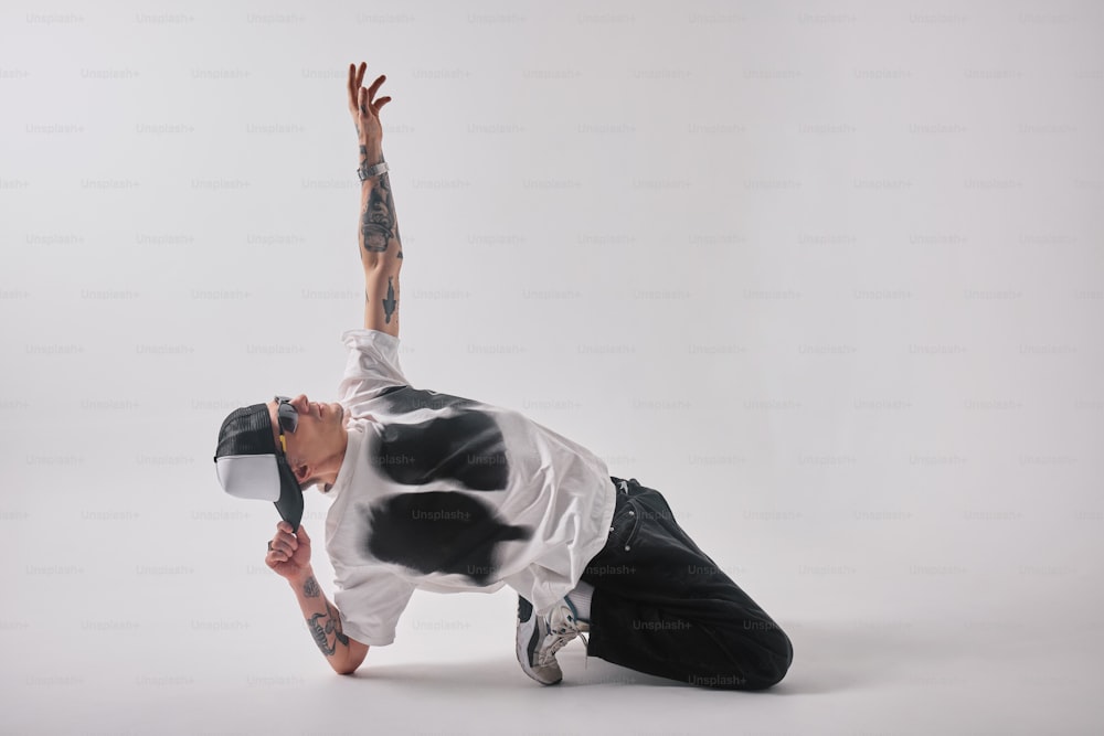 a man in a white shirt and black pants doing a handstand