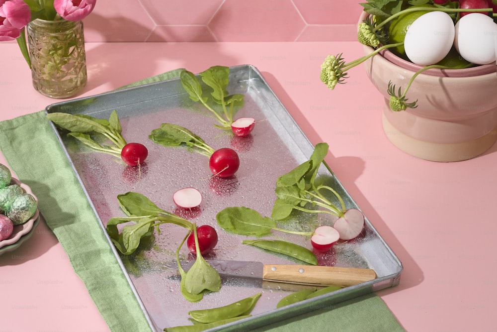 a tray with radishes and other vegetables on it