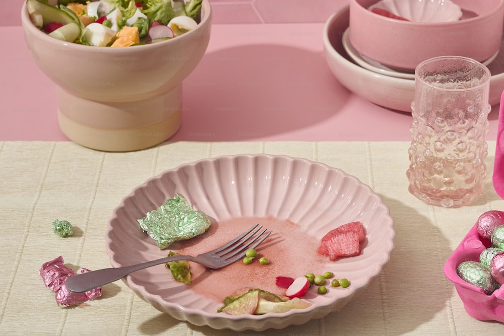 a bowl of candy and a bowl of salad on a table