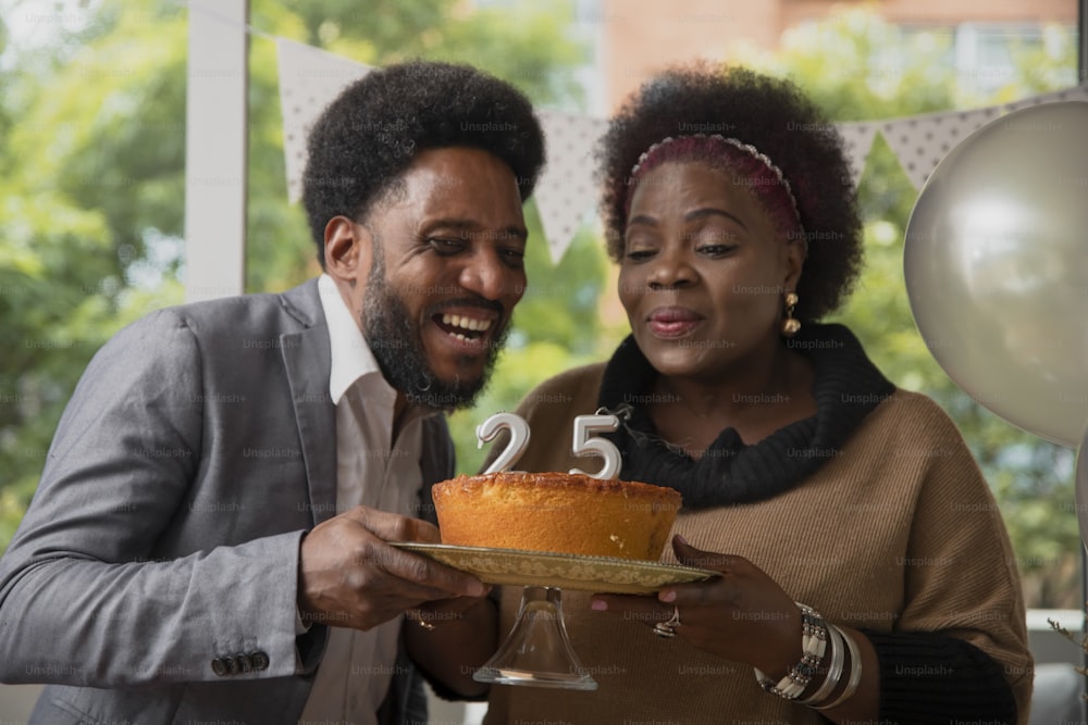 a man and a woman holding a cake