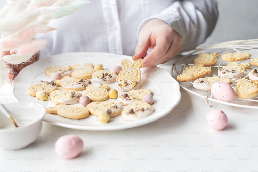 a person putting a cookie on a plate